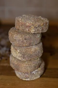 Stack of meatballs ready for cooking in a kitchen setting Stock Photos