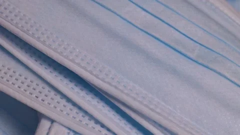Stack of medical protective face masks rotates Stock Footage 228923278