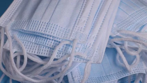 Stack of medical protective face masks rotates. The concept of protection Stock Footage 228923442