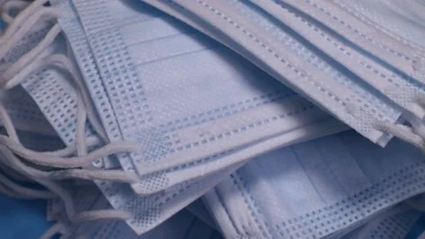 Stack of medical protective face masks rotates. The concept of protection Stock Footage 228923445