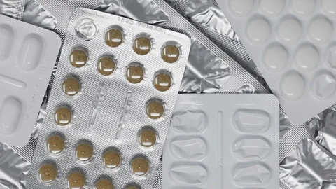 Stack of medication blister packs, rotating slowly Stock Footage 121888319