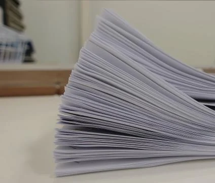 Stack of meeting paper on the table with blurred of office room Stock Photos