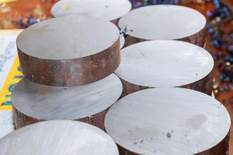 A stack of metal ingots are cut for further processing on a CNC milling machi Stock Photos