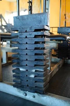 Stack of metal molds in a factory setting Stock Photos