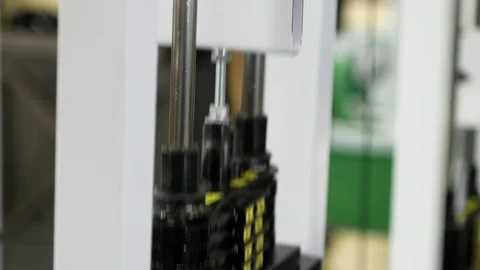 Stack of metal objects in the exercise machine moves up and down.  Stock Footage 152008156