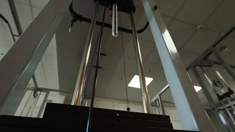 Stack of metal objects in machine moves up and down.  Stock Footage 312379186