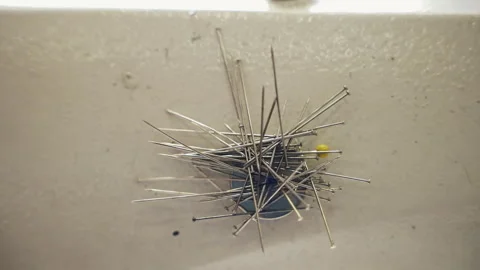 Stack of metal straight pins for sewing on magnet button, necessary sewing tools Stock Footage 250018679