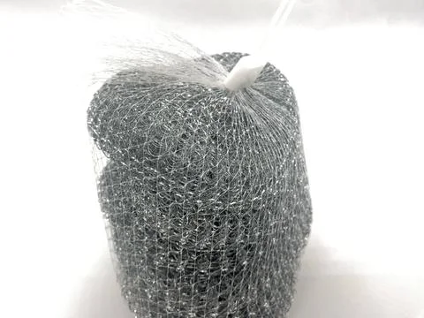Stack of metallic dish scrubbers wrapped in netting on white Stock Photos