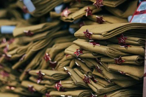 Stack of military caps of the Soviet army with red stars. Garrison cap with a 库存照片