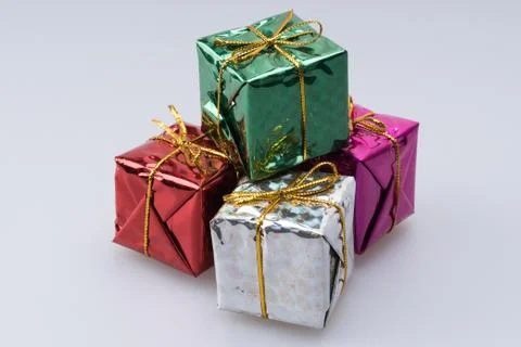 Stack of mini gifts wrapped in shiny paper Foto stock