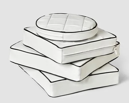 Stack of minimalist square and round white leather seat cushions Fotos Stock