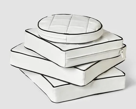 Stack of minimalist square and round white leather seat cushions Stack of ... Stock-Fotos