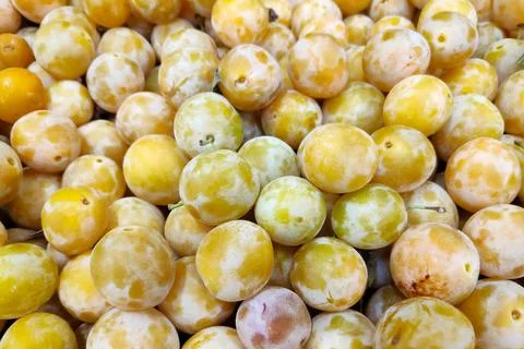 Stack of Mirabelle plums on a market stall Stock Photos