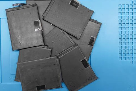 A stack of mobile phone batteries in the workshop Stock Photos