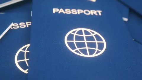 Stack of Modern Blue Passports With Global Icon in Soft Focus Stock Footage 308671764