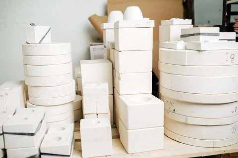 Stack of molds for casting tableware of different size and shape. Stock Photos
