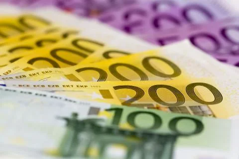Stack of money with 100 focused 200 and 500 euro. Perfect for illustrating e. Stock Photos