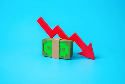 A stack of money and an arrow pointing down. A drop in income, salary cut, fi Stock Photos