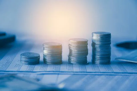 Stack of money coin on accounting sheet with selective focus Stock Photos