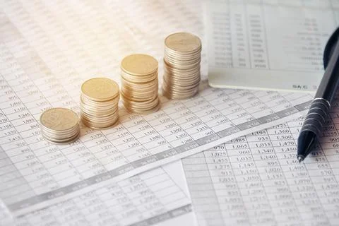 Stack of money coin on accounting sheet with selective focus Stock Photos
