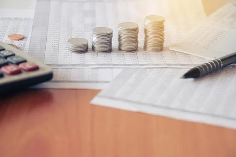 Stack of money coin on accounting sheet with selective focus Stock Photos