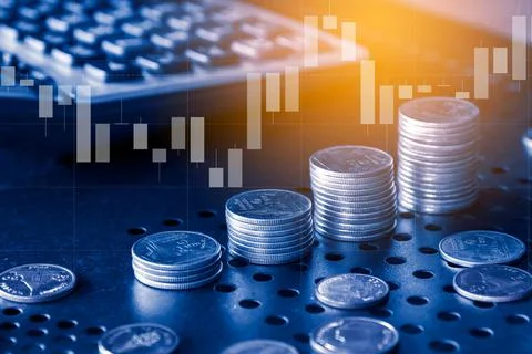 Stack of money coin with trading graph, financial investment concept Stock Photos