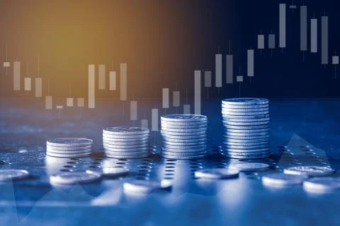 Stack of money coin with trading graph, financial investment concept Stock Photos