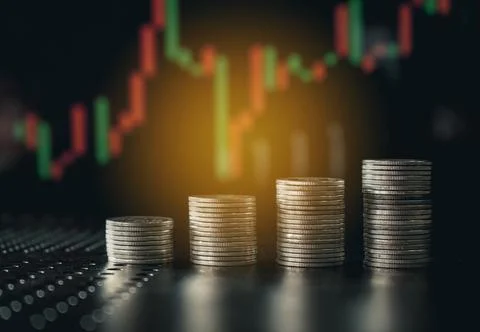 Stack of money coin with trading graph, financial investment concept Stock Photos