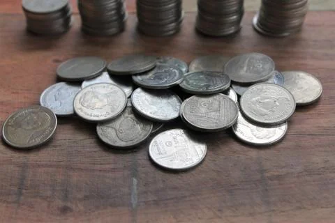 Stack of money coins arranged as a graph on wooden table Stock Photos