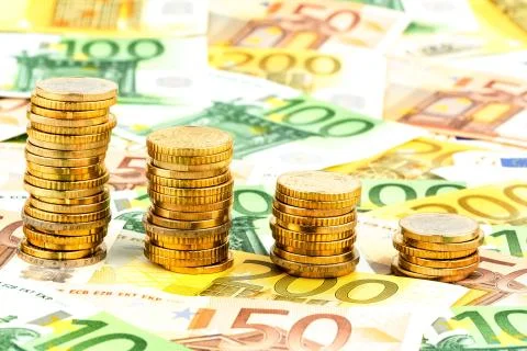 Stack of money coins, falling graph Stock Photos