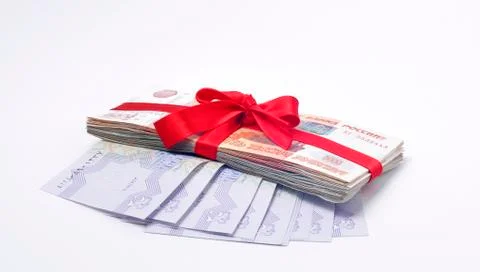 Stack of money tied with red gift tape Foto stock