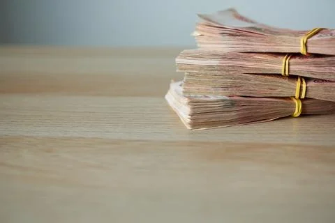 Stack of money on wooden table with copy space, business and finance concept 写真素材