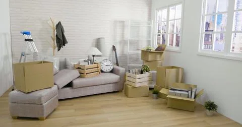 Stack of moving boxes in new house living room Stock Photos