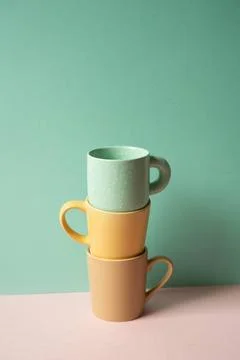Stack of mug cup on pink table. mint green wall background Stack of mug cu... Stock Photos
