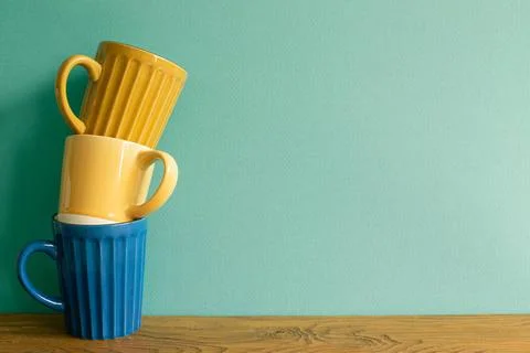 Stack of mug cup on wooden table. mint wall background. copy space Stack o... Stock Photos