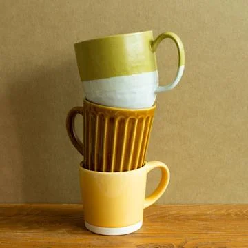 Stack of mug cup on wooden table. brown wall background. copy space Stack ... Stock Photos