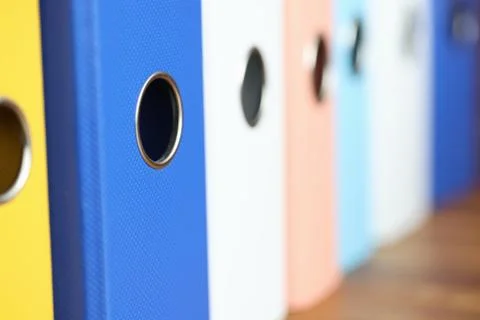 Stack of multi-colored folders is on the table. 写真素材