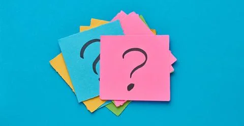 A stack of multi-colored square sticky notes with a question mark on them, .. Stock Photos