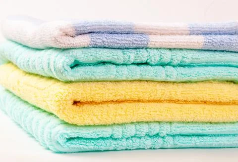 A stack of multi-colored terry towels folded in a pile Foto stock