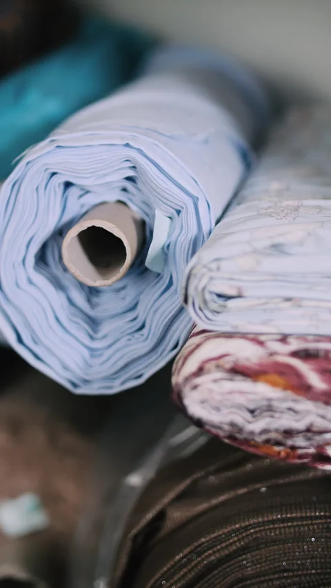 Stack of multicolored fabric rolls in textile storage Stock Footage 308723619