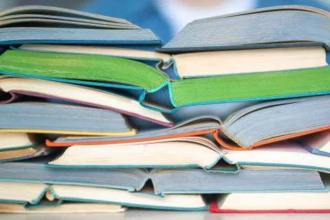 Stack of multicolored open books closeup, back to school concept Stock Photos