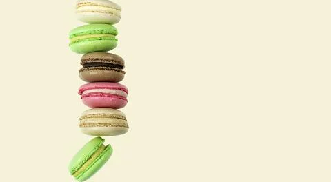Stack of multicolored pasta cakes on pink background with copy space Foto stock