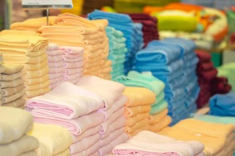 Stack of the multicolored towels on shelf Stock Photos