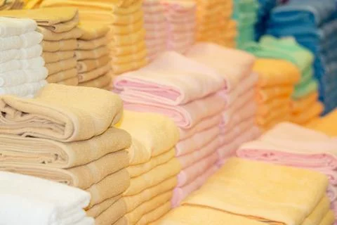 Stack of the multicolored towels on shelf Stock Photos
