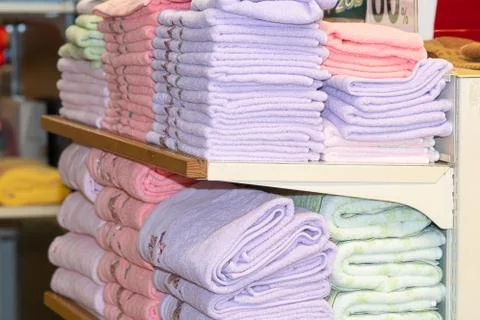 Stack of the multicolored towels on shelf 库存照片