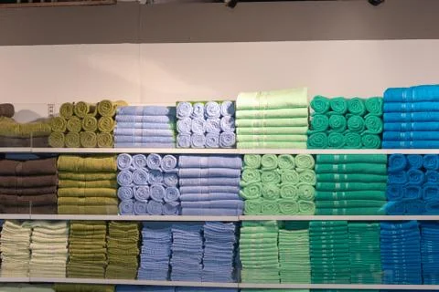 Stack of the multicolored towels on shelf Stock Photos