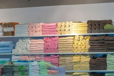 Stack of the multicolored towels on shelf Stock-Fotos