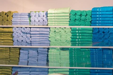 Stack of the multicolored towels on shelf Stock-Fotos