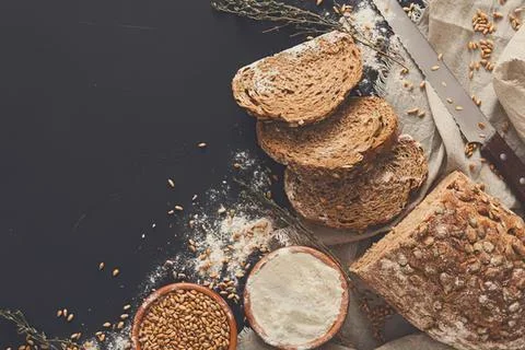 Stack of multigrain bread slices on a rustic table Stock Photos