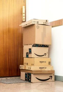 Stack of multiple Amazon prime order arranged near door Stock Photos
